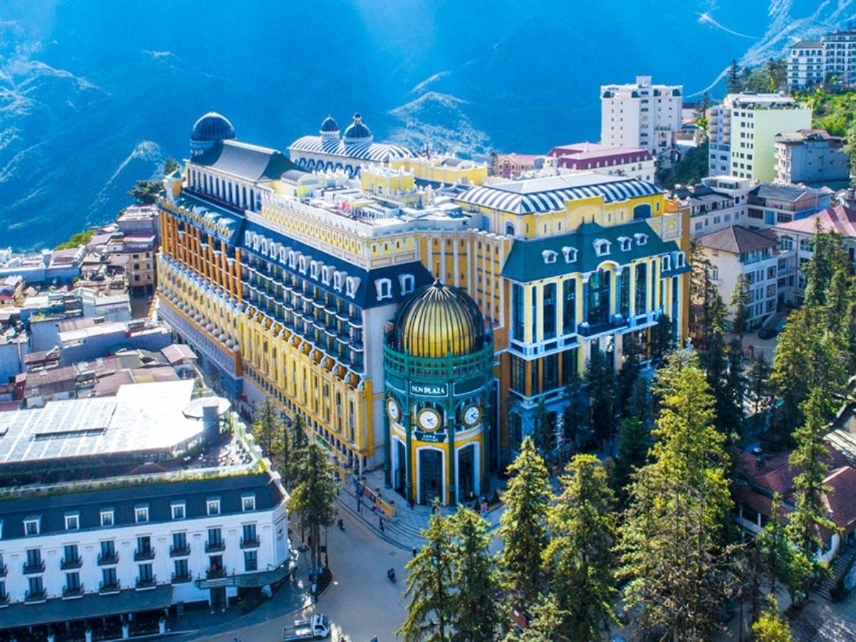 The yellow-and-green European-style Sun Plaza seen from above in the centre of Sa Pa.