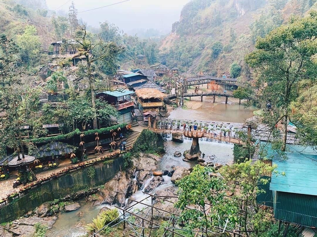 Overview of Cat Cat village from above: the stream, bridges and houses along the hillside.