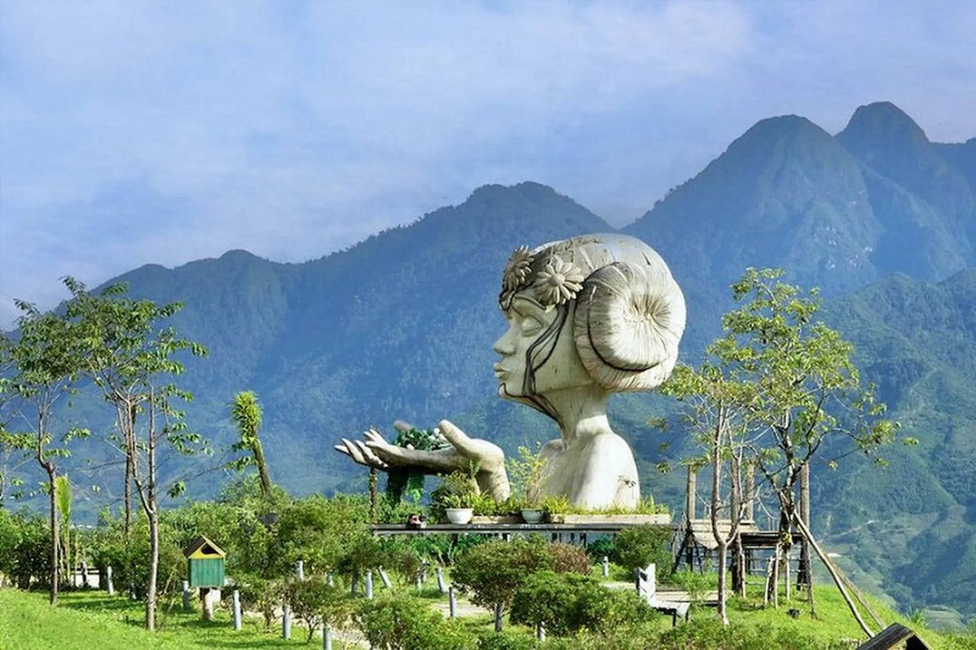 The giant Moana girl statue in the garden, with the Hoang Lien Son range behind.