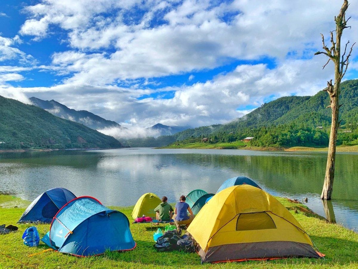 Camping tents on the grassy shore of Seo My Ty lake.