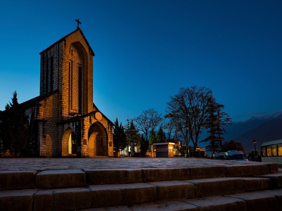 The Stone Church lit up in warm light at dusk.