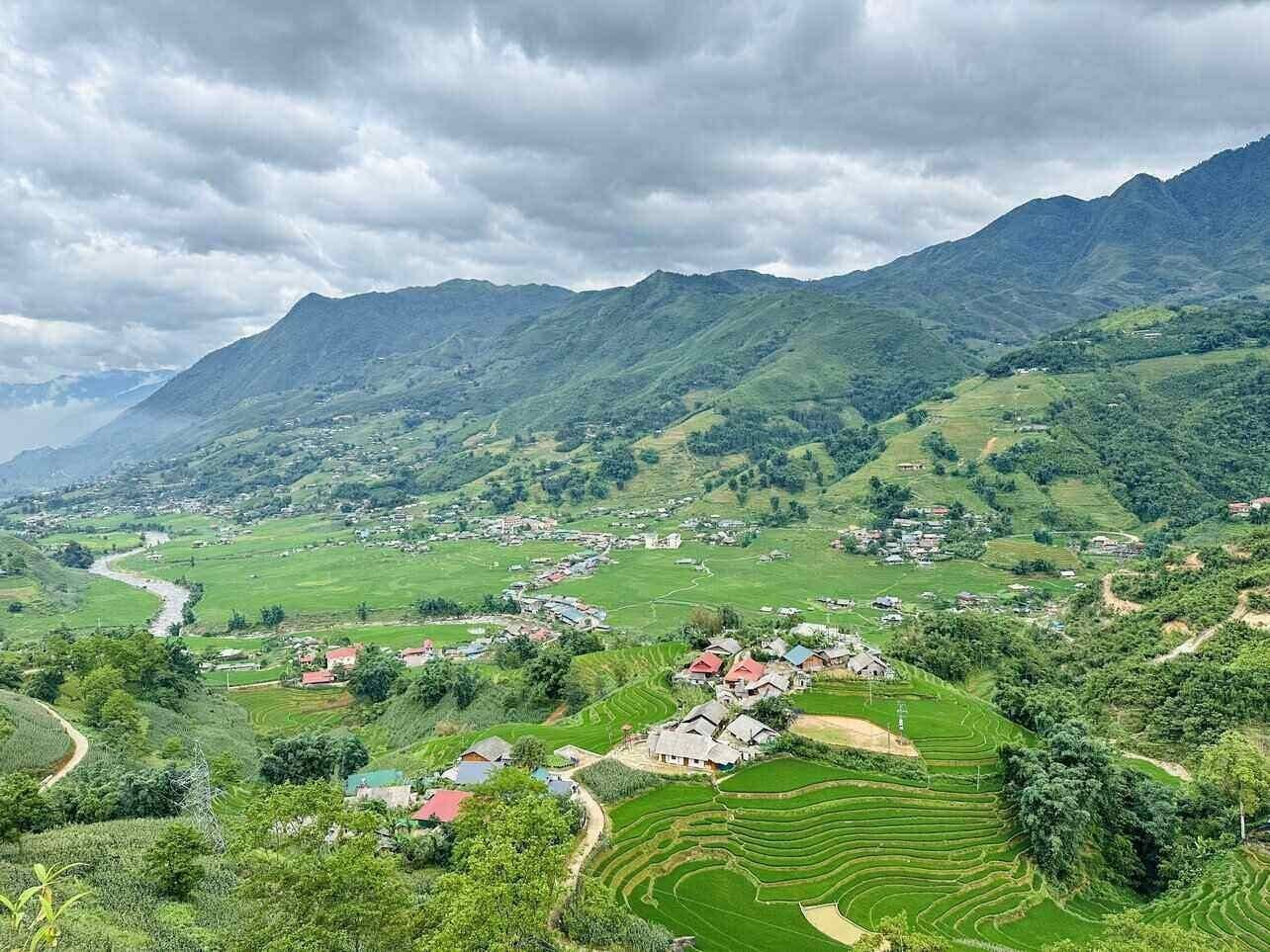 The Ta Phin valley with its village, terraced fields and the mountain range behind.