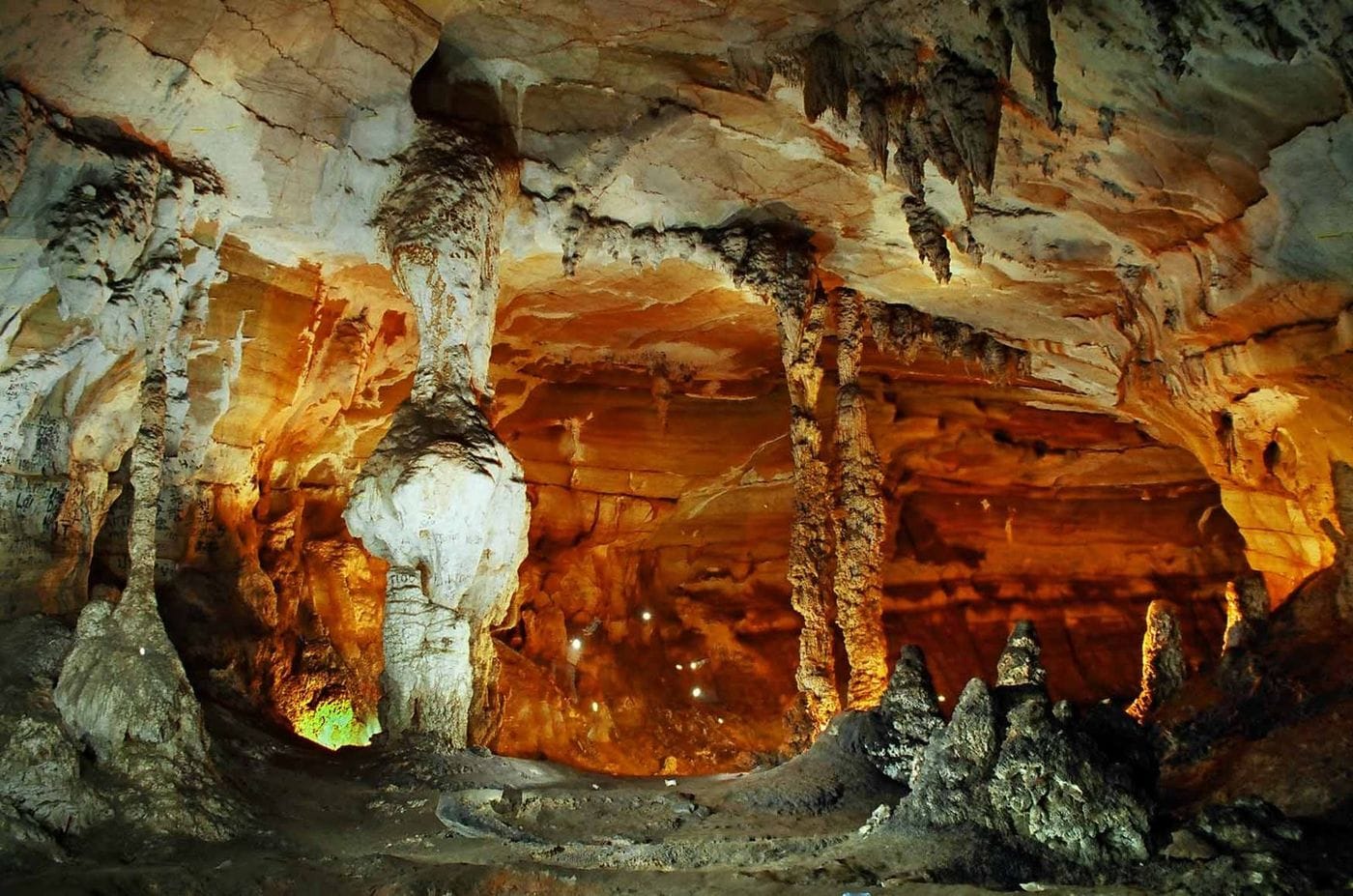 Inside Ta Phin cave, with illuminated stalactites and stalagmites.