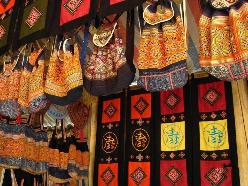 Colourful embroidered bags and textiles for sale in Ta Phin.