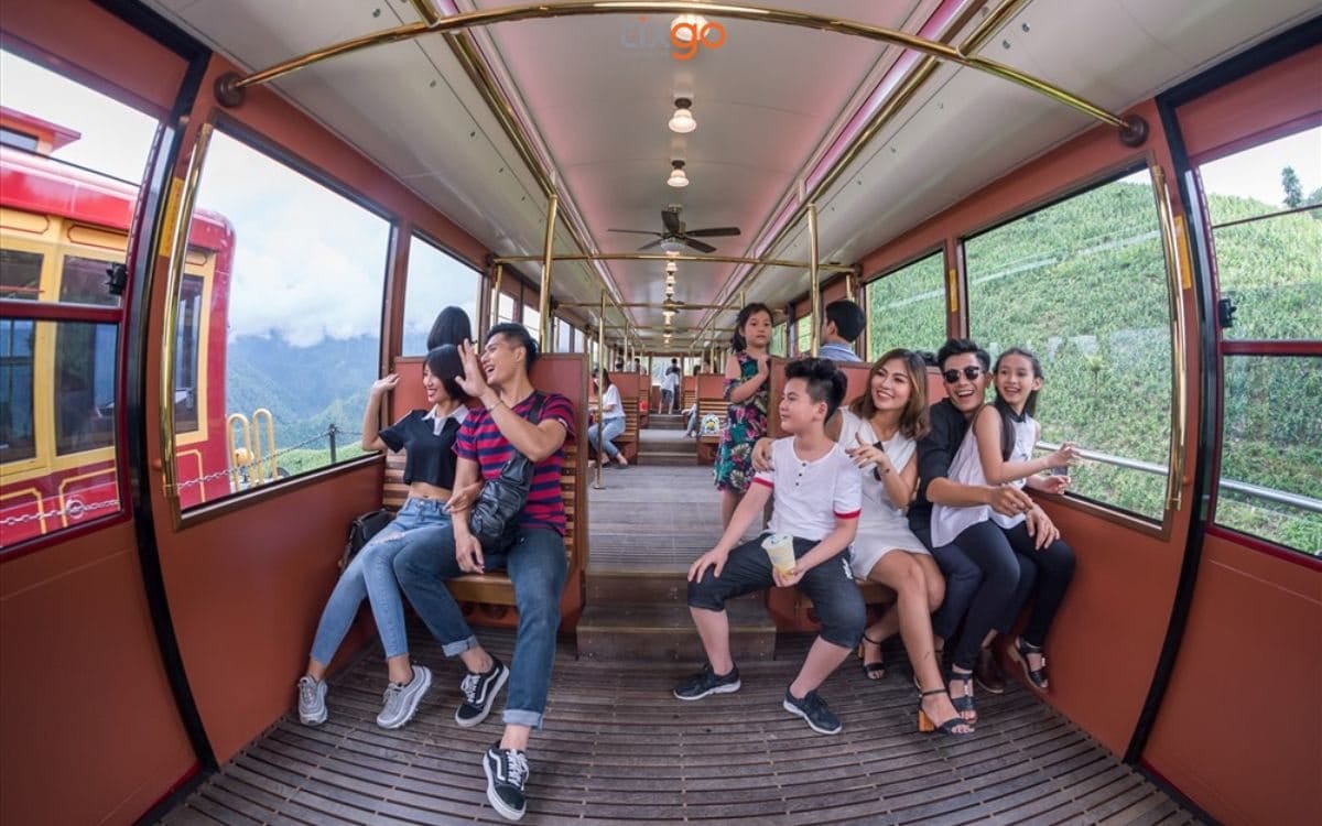 Passengers inside the car, with windows onto the tea hills and valley on both sides